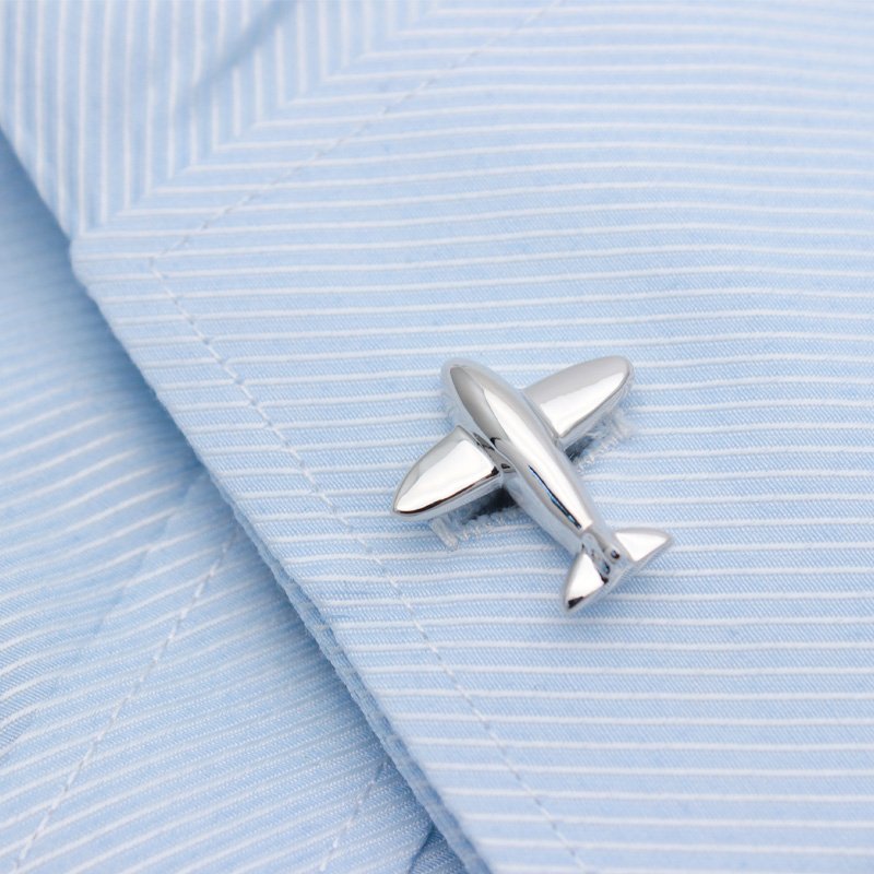 A pair of stylish airplane model cufflinks made from titanium alloy, presented in a hard-sided box, perfect for formal occasions.