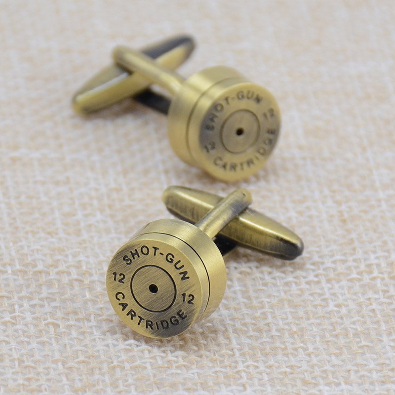 A pair of stylish brass bullet cufflinks, featuring a sleek stainless steel base with brass plating, elegantly displayed in a gift box.
