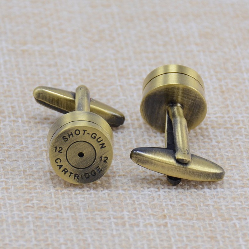 A pair of stylish brass bullet cufflinks, featuring a sleek stainless steel base with brass plating, elegantly displayed in a gift box.