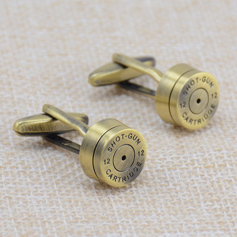 A pair of stylish brass bullet cufflinks, featuring a sleek stainless steel base with brass plating, elegantly displayed in a gift box.