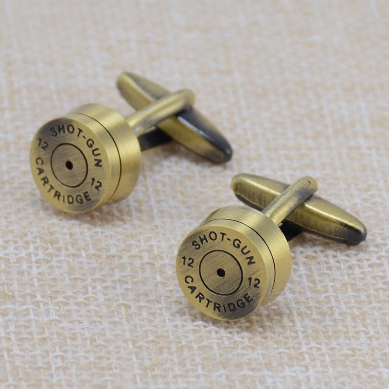 A pair of stylish brass bullet cufflinks, featuring a sleek stainless steel base with brass plating, elegantly displayed in a gift box.