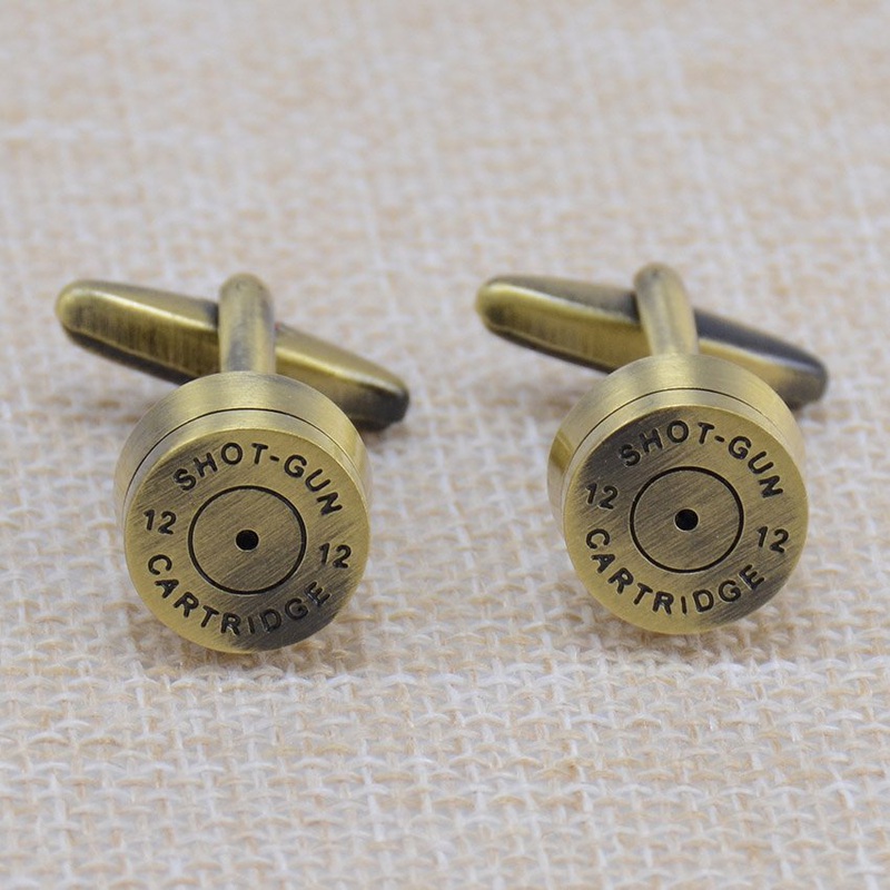 A pair of stylish brass bullet cufflinks, featuring a sleek stainless steel base with brass plating, elegantly displayed in a gift box.