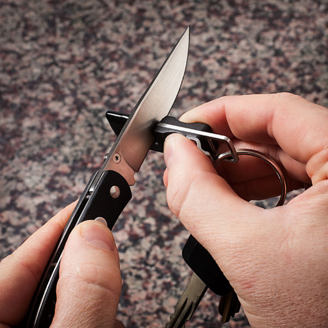 Compact Knife Sharpener Key Ring with carbide blades and ceramic stones for quick sharpening.
