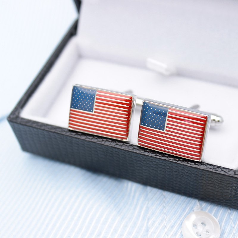A pair of United States Flag Cufflinks made from titanium alloy, featuring a hand-painted finish, displayed in a hard-sided presentation box.