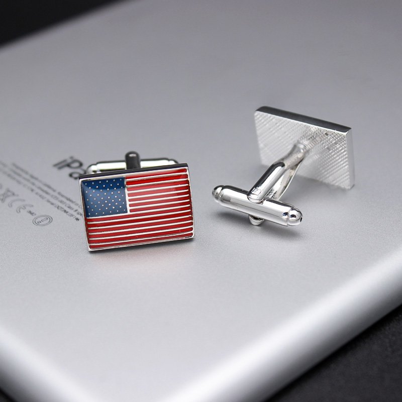 A pair of United States Flag Cufflinks made from titanium alloy, featuring a hand-painted finish, displayed in a hard-sided presentation box.