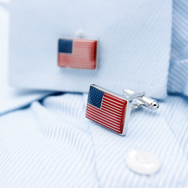 A pair of United States Flag Cufflinks made from titanium alloy, featuring a hand-painted finish, displayed in a hard-sided presentation box.