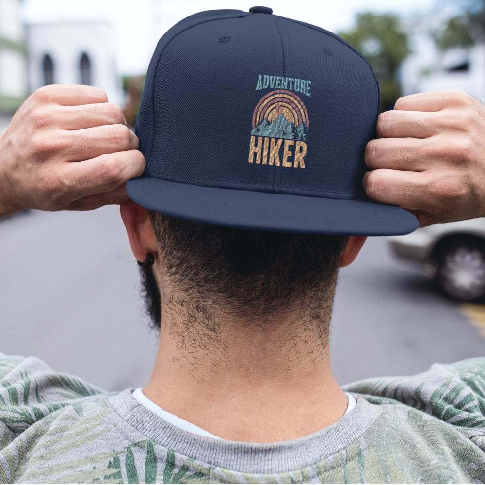 Adventure Hiker Embroidered Flat Bill Cap featuring a structured design, green under visor, and snapback closure, perfect for outdoor activities.