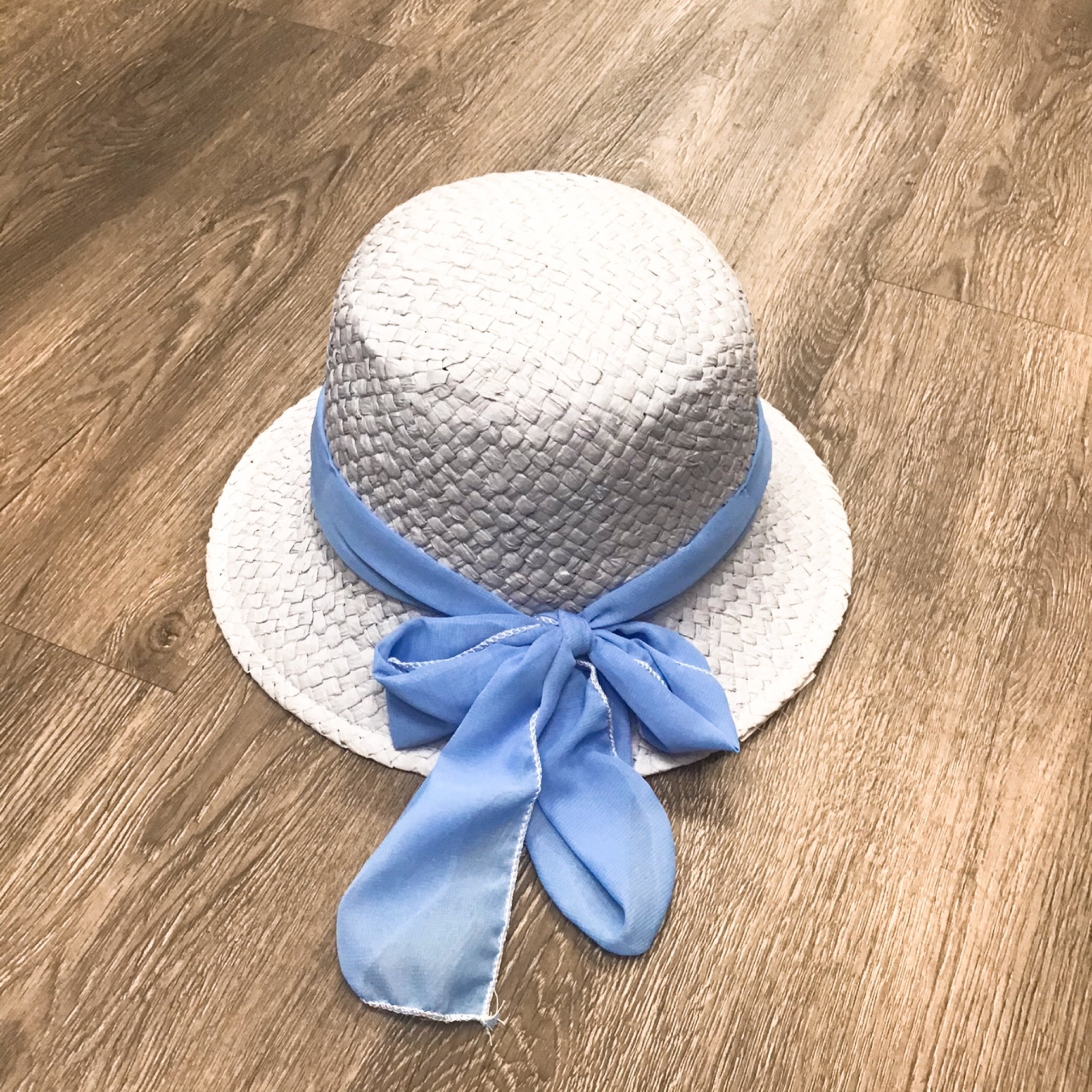 A baby blue bucket hat with a stylish bow detail, perfect for kids.