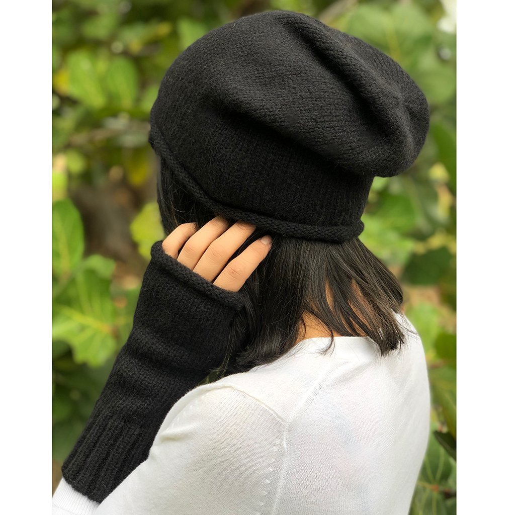 A stylish black essential knit alpaca beanie, showcasing its slouchy design and luxurious texture, handmade in Peru.