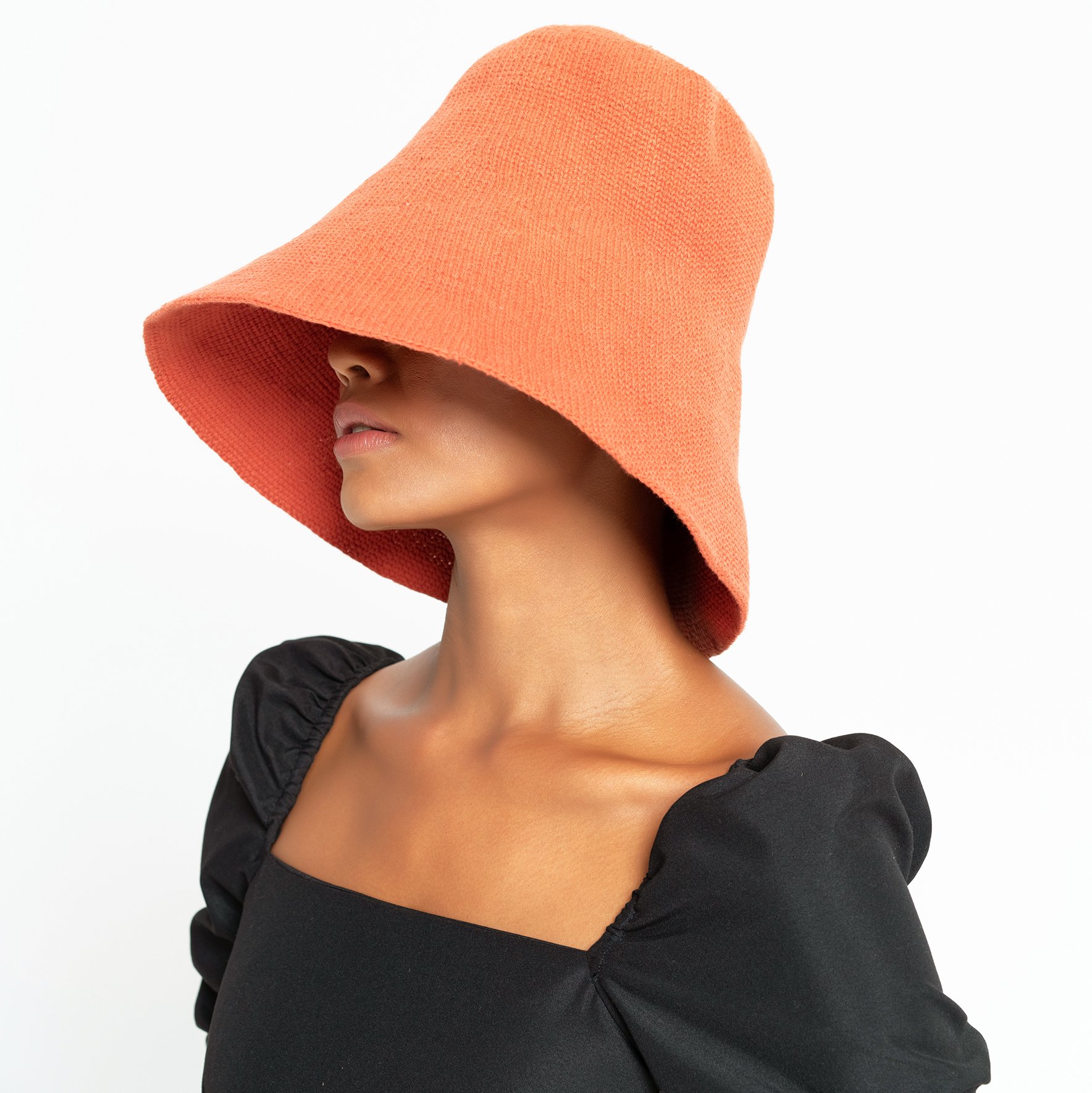 BLOOM Crochet Hat in Burnt Sienna, showcasing its soft crochet texture and Calla Lily-inspired shape.