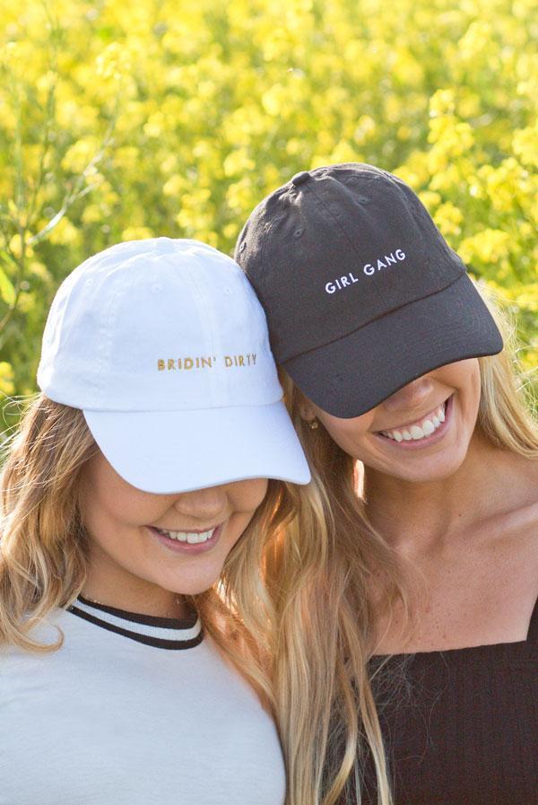 Bride and Girl Gang bachelorette party dad hats in white and black, featuring stylish text designs.
