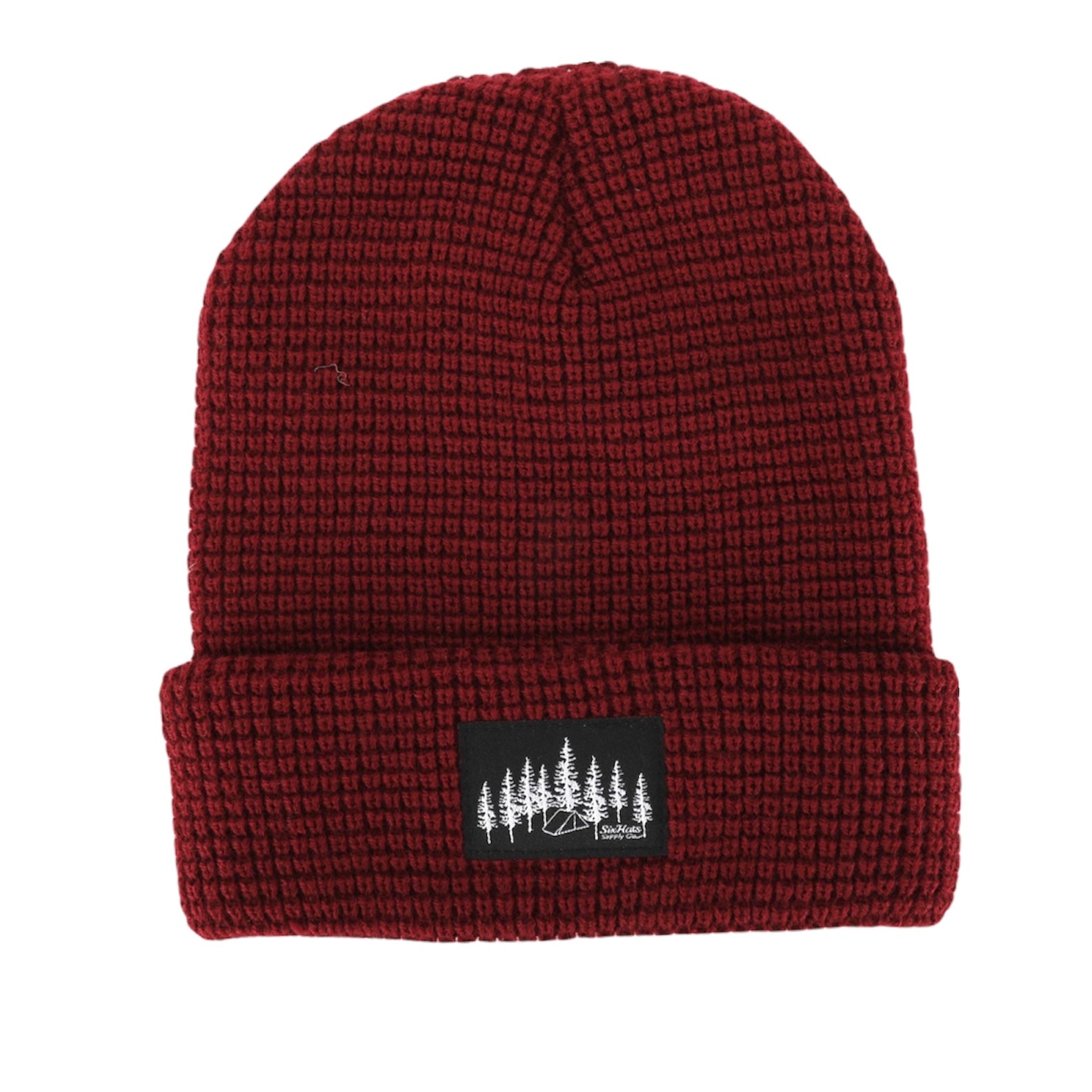 Burgundy Explorer Waffle Beanie displayed on a wooden surface, showcasing its thick knitted texture and stylish design.