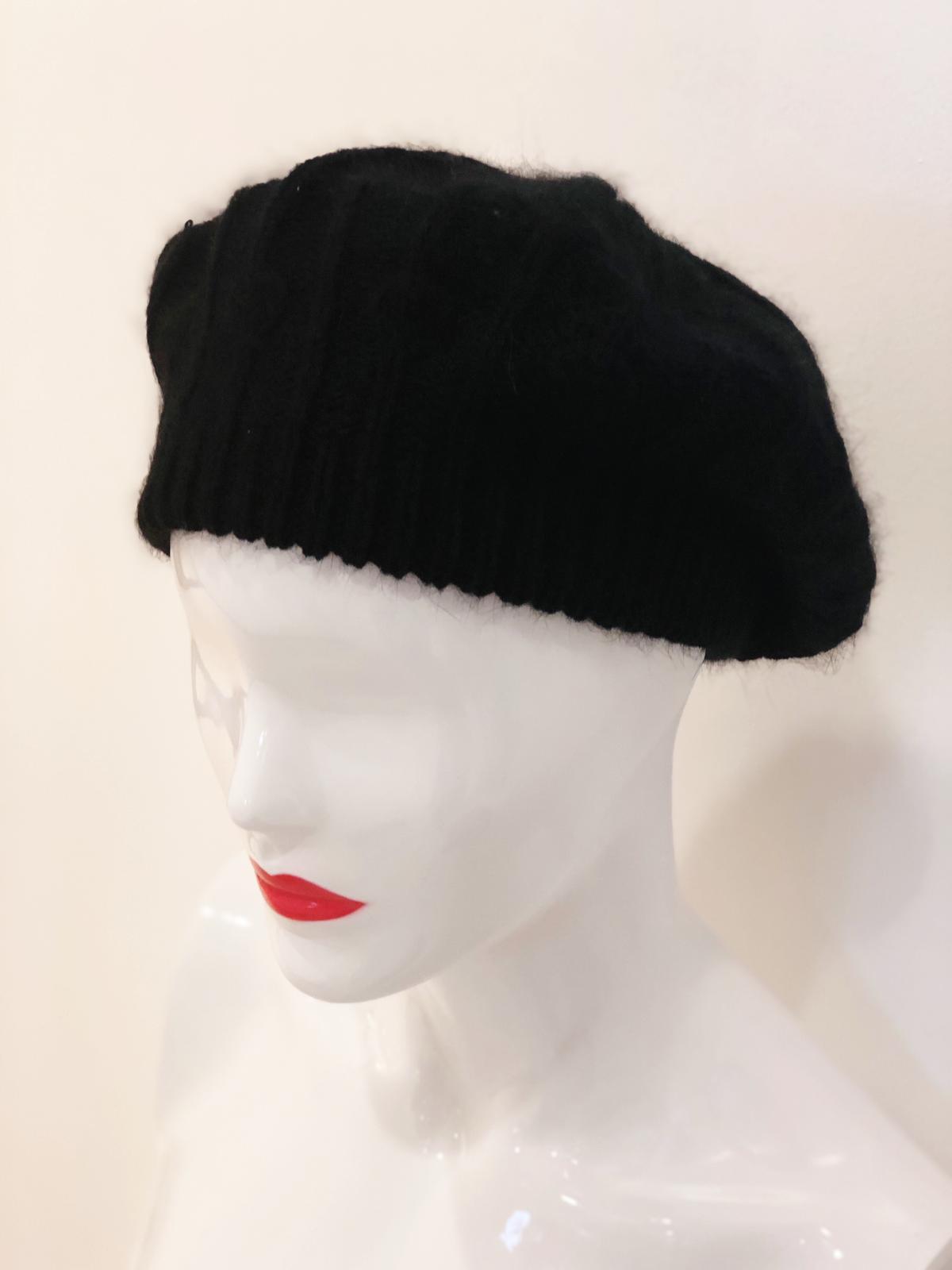 A stylish 'Cassidy' Black Beret, showcasing its classic design and soft fabric, perfect for enhancing any outfit.