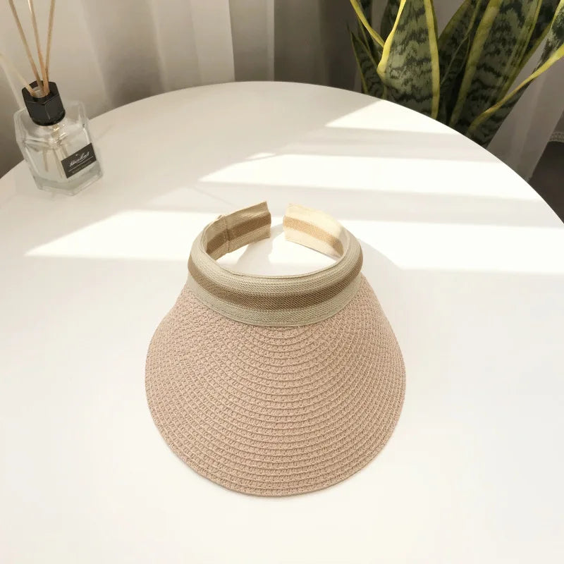Cindy Visor hat made of straw, designed for women's sun protection, featuring a stylish and casual look for spring and summer.