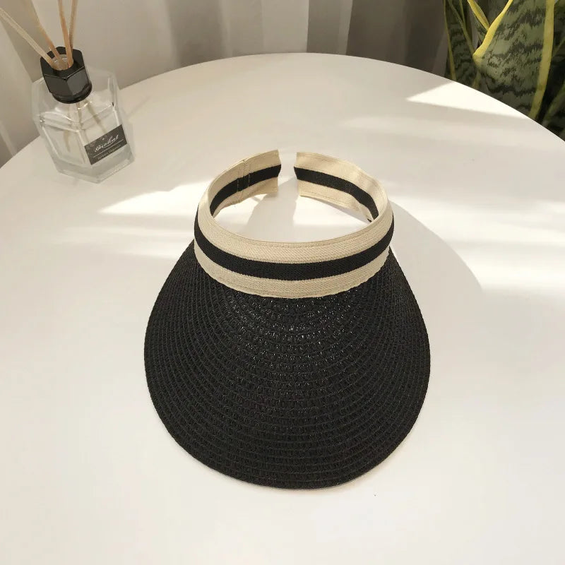 Cindy Visor hat made of straw, designed for women's sun protection, featuring a stylish and casual look for spring and summer.