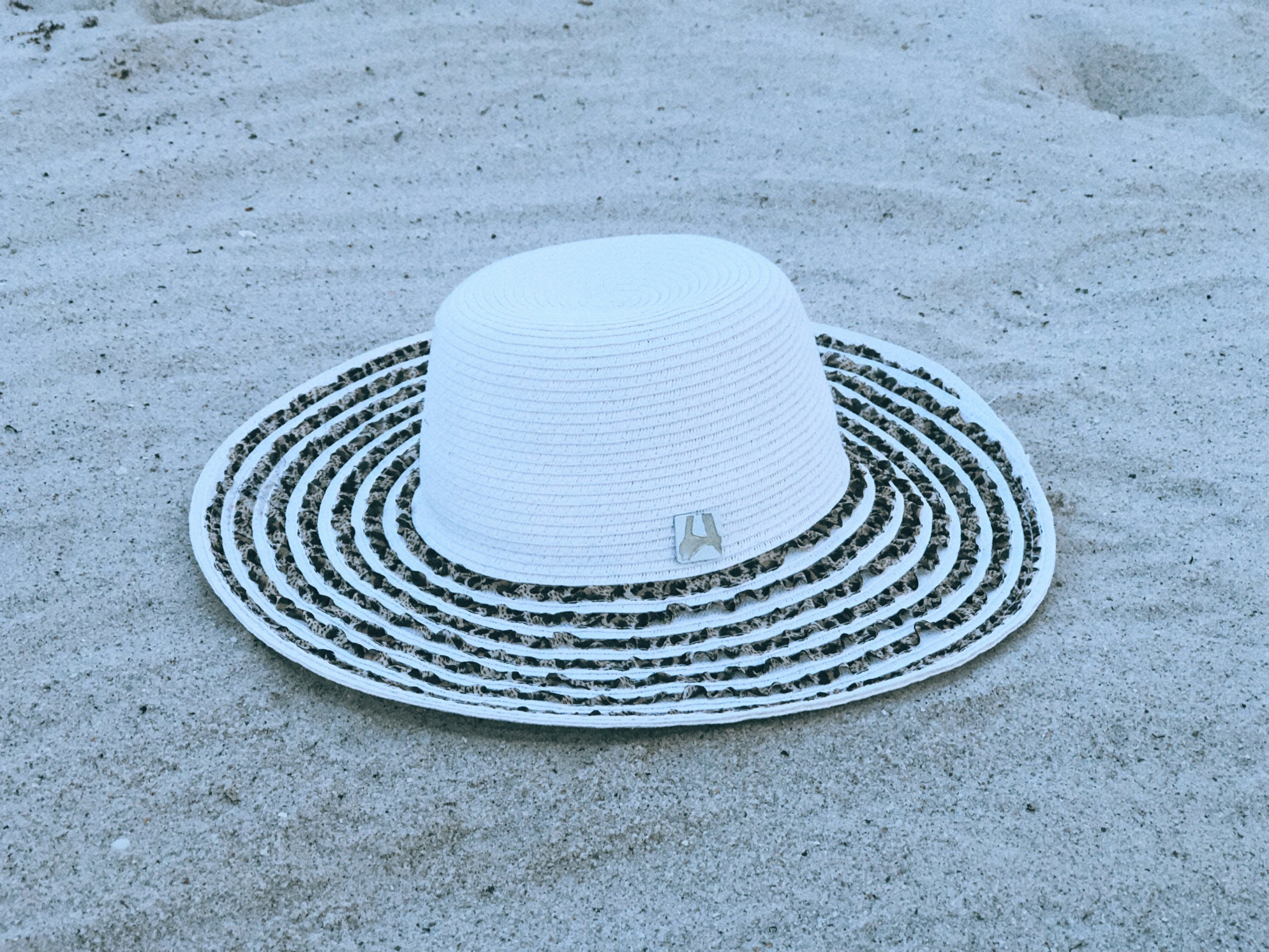 Fancy Feline Sun Floppy Hat with animal print ribbon and wide brim, perfect for sunny days.