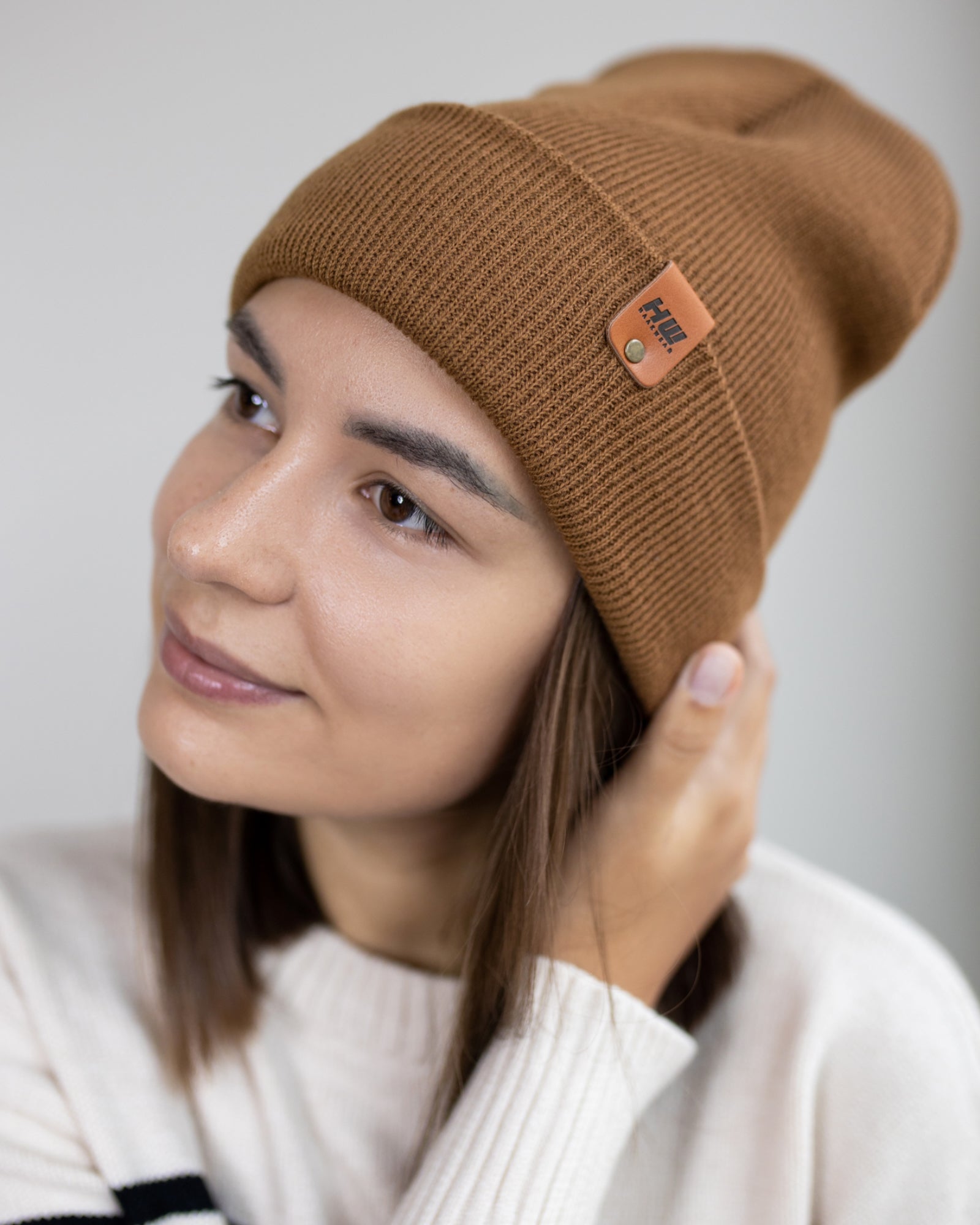 HAAKWEAR Knit Cuffed Beanie in Camel Brown, showcasing its stylish design and soft texture.
