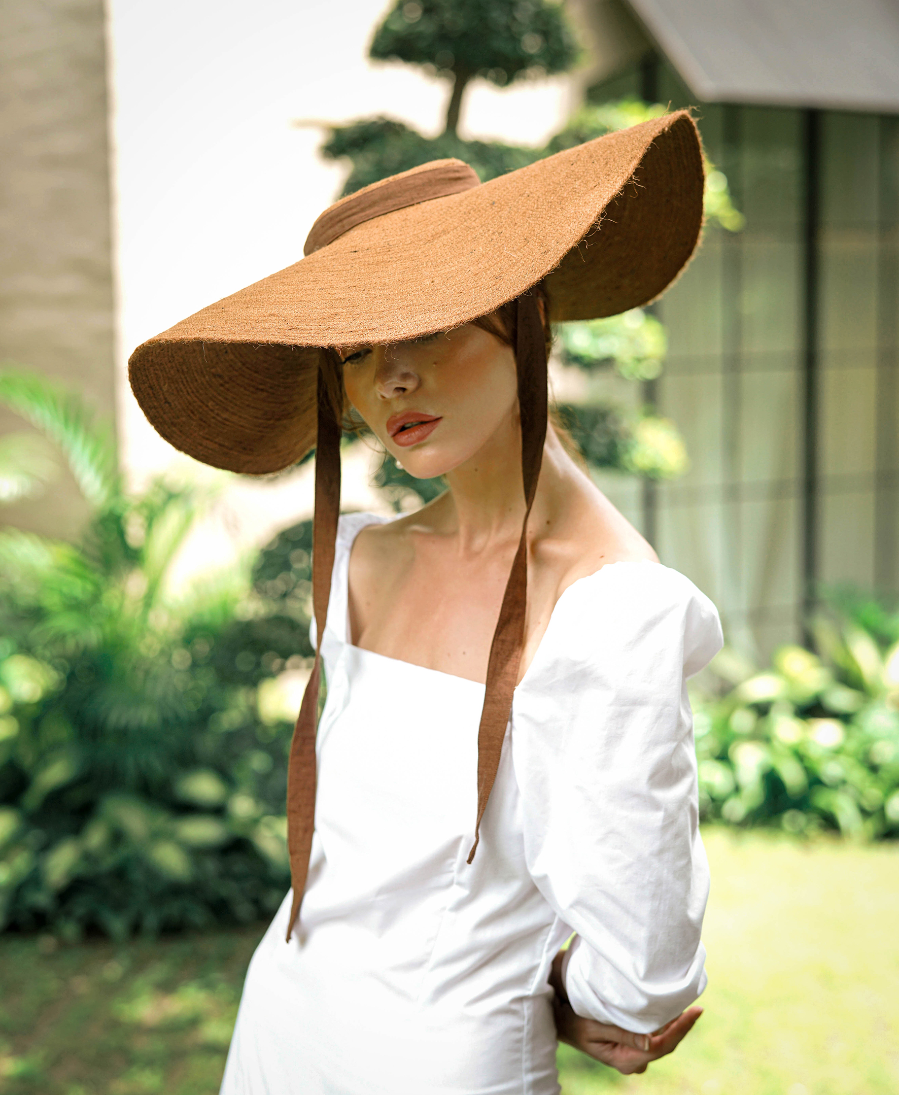 Lola Wide Brim Jute Straw Hat in Havana Brown, showcasing its elegant design and natural jute material.