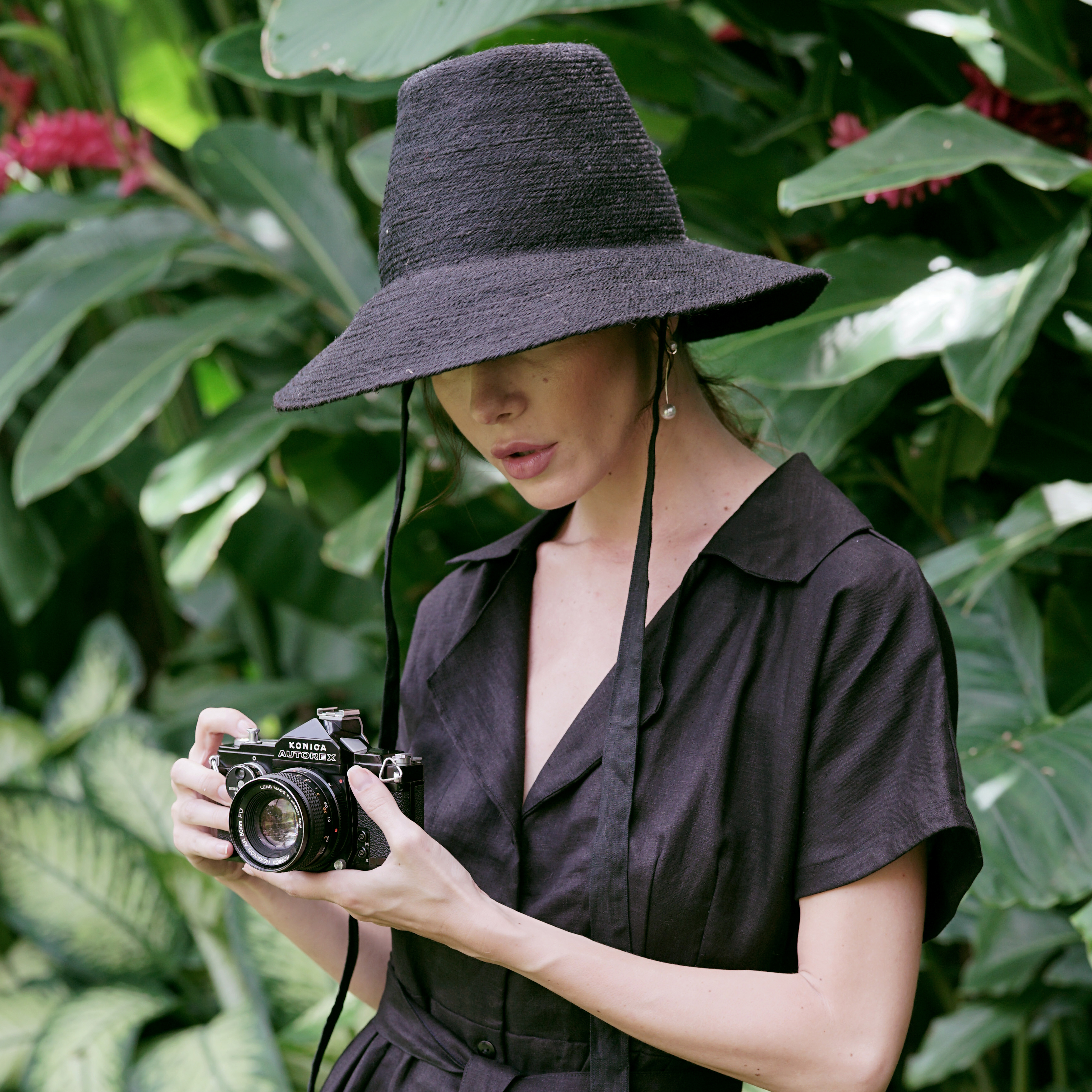 MEG Jute Straw Hat in Black with a tall crown and medium-width brim, crafted from natural jute and lined with linen fabric.