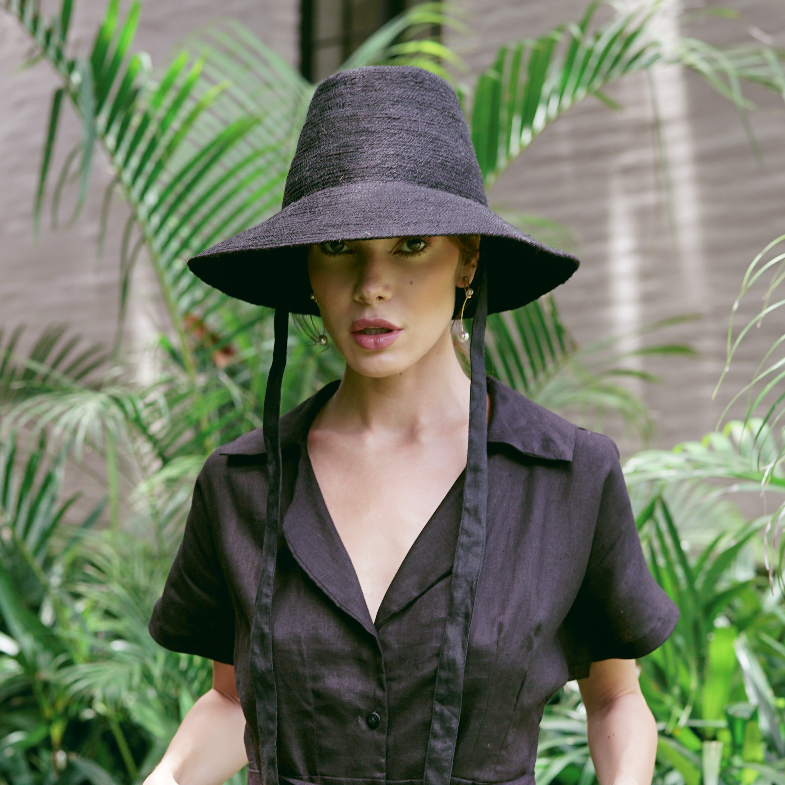 MEG Jute Straw Hat in Black with a tall crown and medium-width brim, crafted from natural jute and lined with linen fabric.