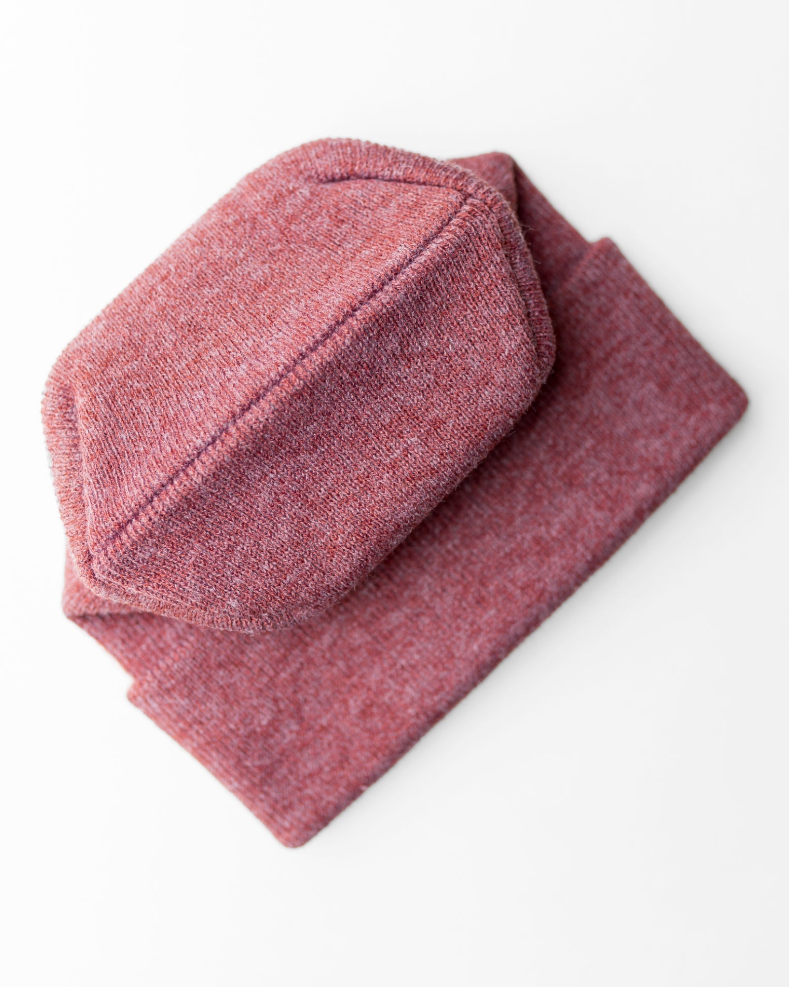NEW HAAKWEAR Theta-Stitch Cuffed Beanie in Rusty Burgundy, showcasing its unique design and comfortable fit.