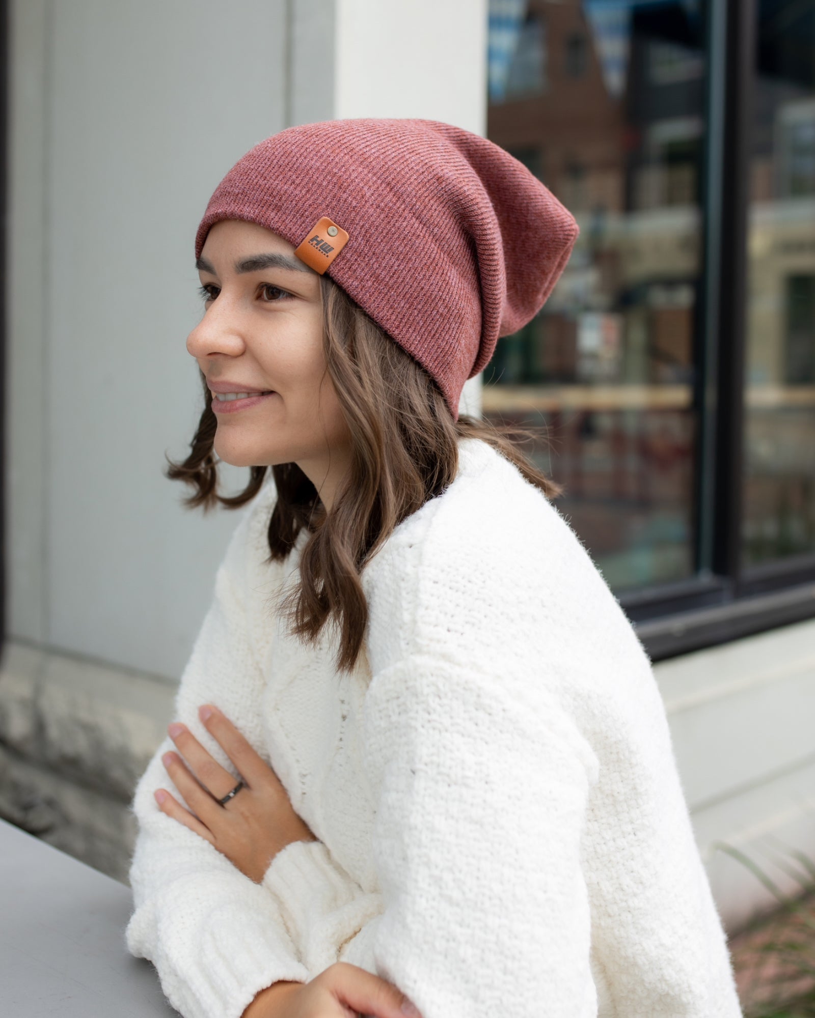 NEW HAAKWEAR Theta-Stitch Cuffed Beanie in Rusty Burgundy, showcasing its unique design and comfortable fit.