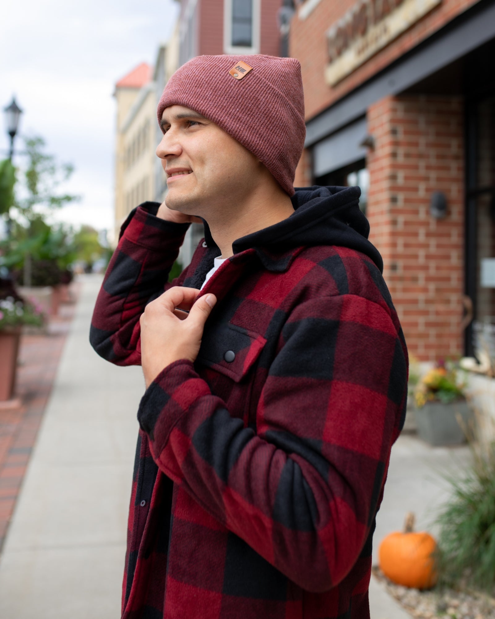 NEW HAAKWEAR Theta-Stitch Cuffed Beanie in Rusty Burgundy, showcasing its unique design and comfortable fit.