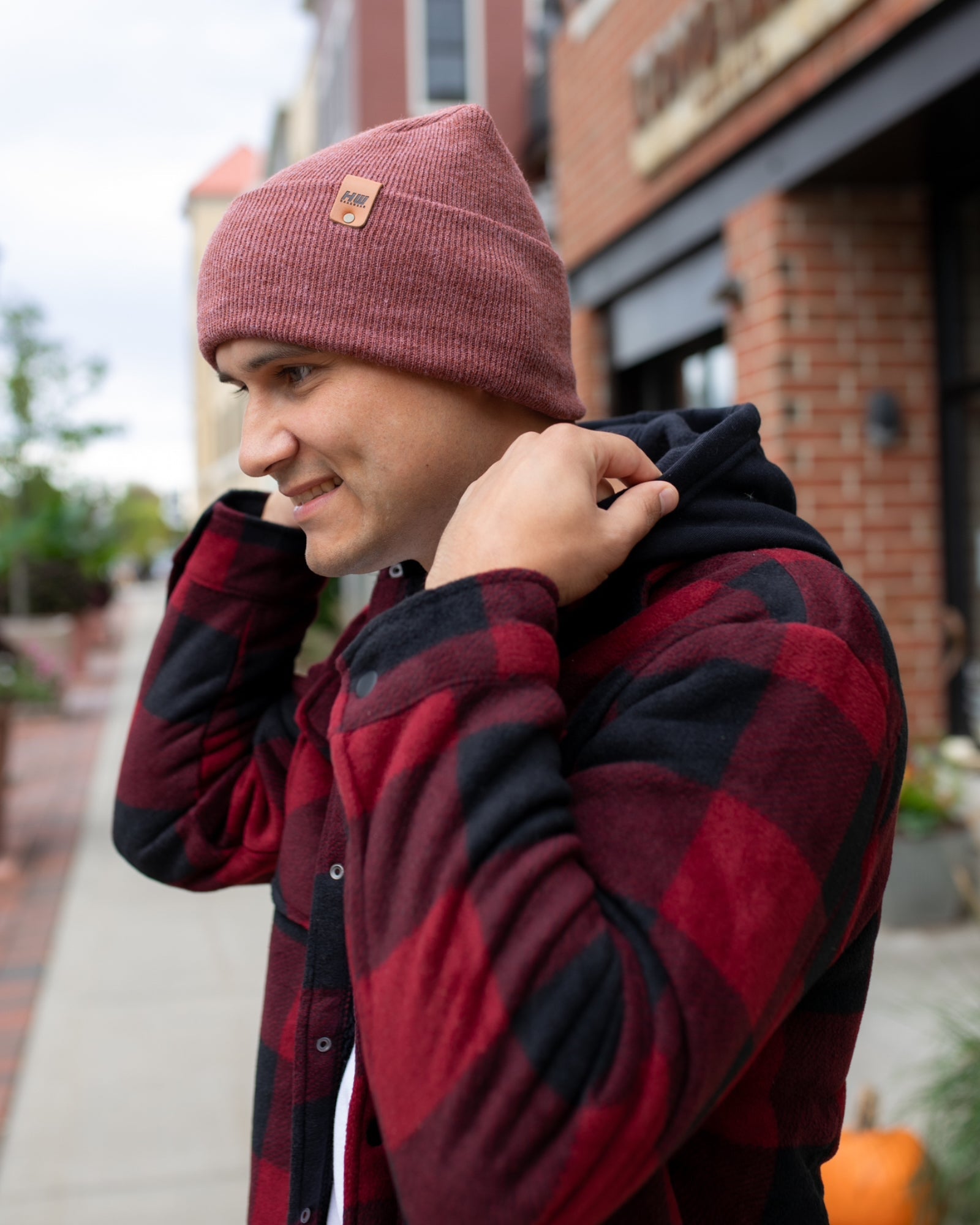 NEW HAAKWEAR Theta-Stitch Cuffed Beanie in Rusty Burgundy, showcasing its unique design and comfortable fit.