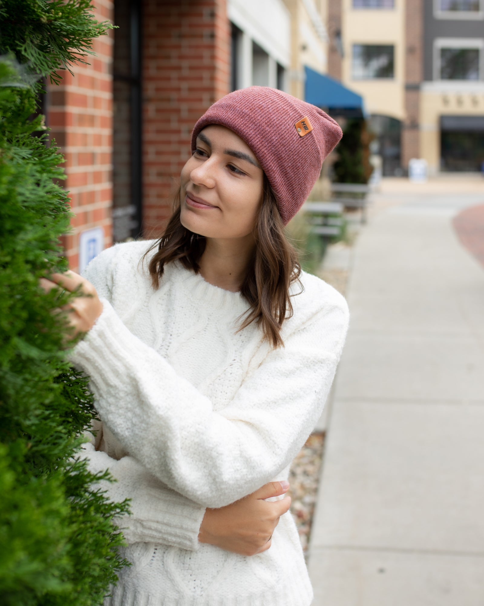 NEW HAAKWEAR Theta-Stitch Cuffed Beanie in Rusty Burgundy, showcasing its unique design and comfortable fit.