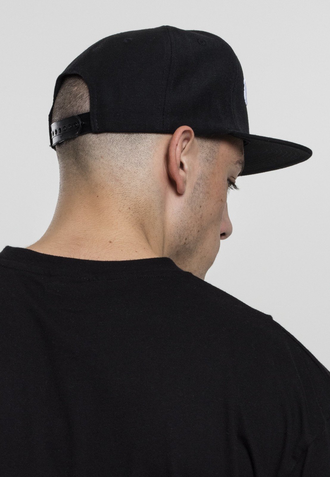 Thug Life Old English Snapback cap featuring classic design and adjustable strap, made from polyester, cotton, and elastane blend.