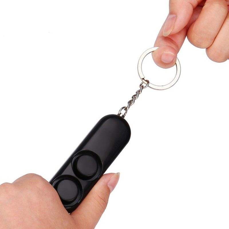 Two personal safety alarms in black and pink, featuring a keychain design for easy attachment and a dual speaker system for loud 120dB sound.