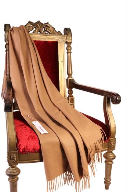 Luxurious beige plaid made from 100% alpaca wool, showcasing its soft texture and elegant design.