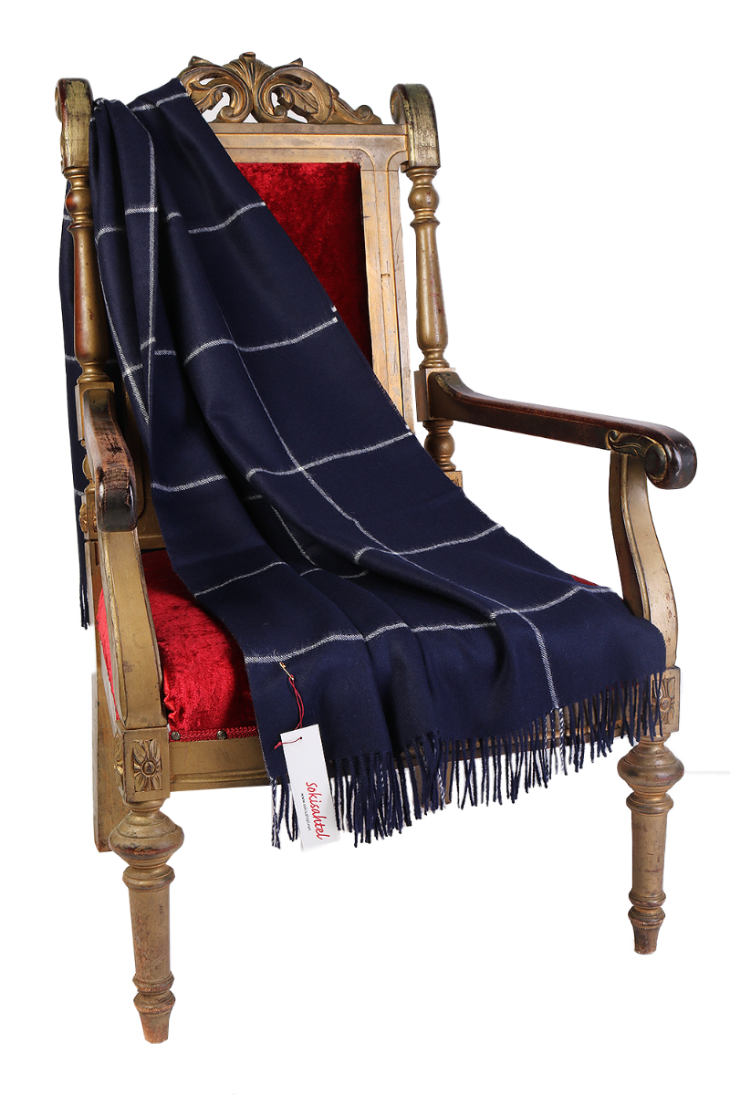 Luxurious dark blue checkered plaid made from 100% alpaca wool, showcasing its soft texture and elegant design.