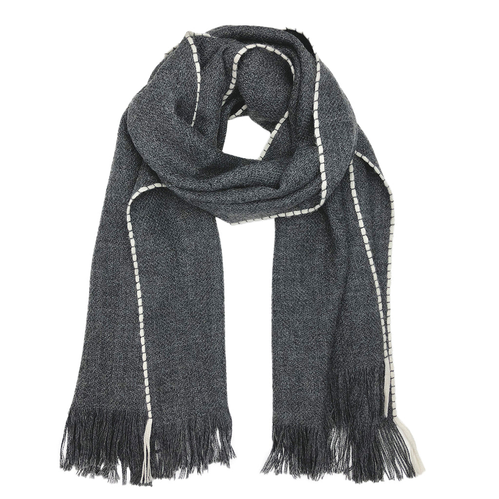 A luxurious Andes Charcoal Baby Alpaca Scarf featuring a charcoal gray color with a snow white edge, showcasing its soft texture and fringe details.
