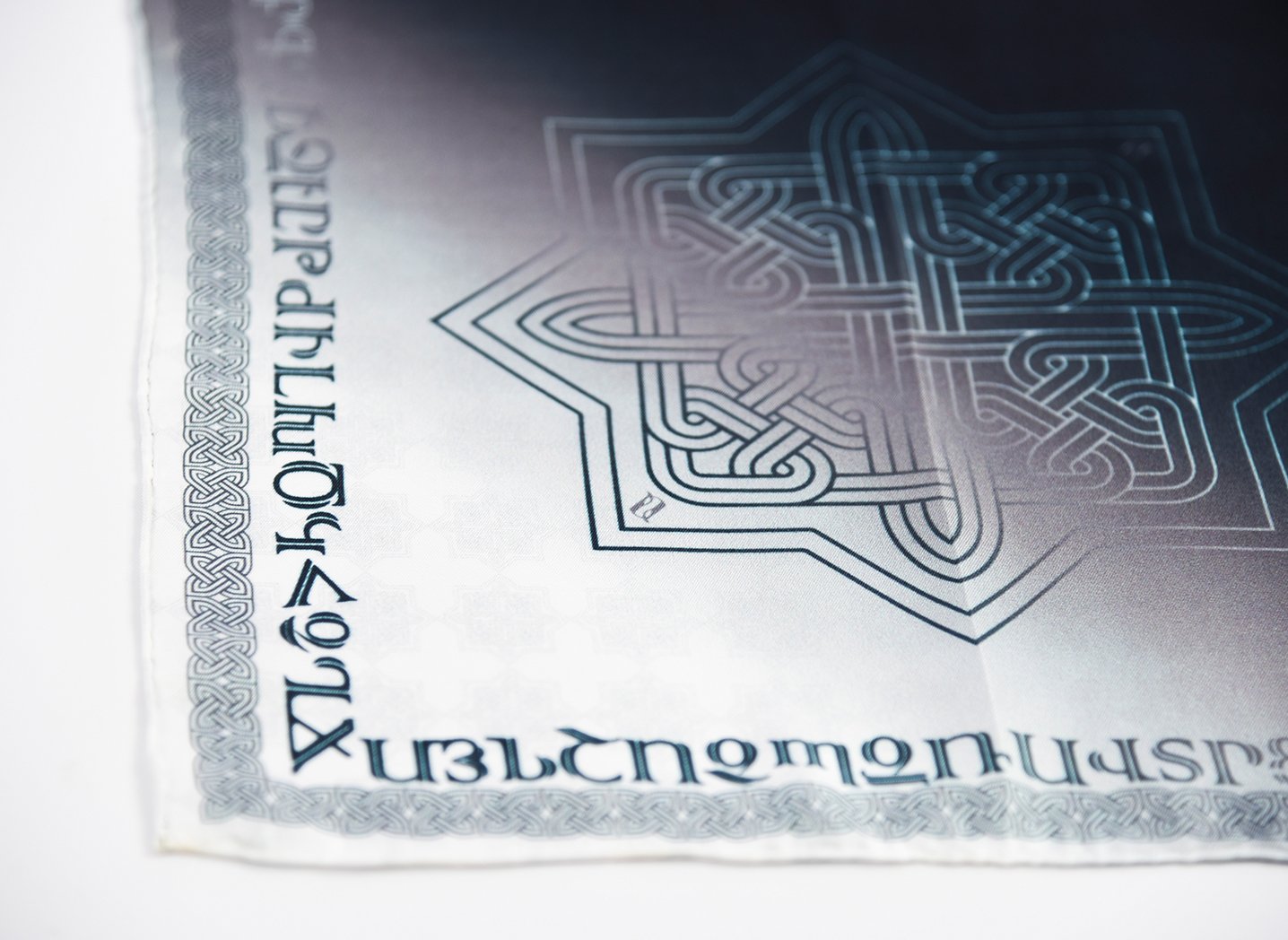 Armenian Alphabet and Eternity Pocket Square in silk twill, featuring black, grey, and white colors with intricate ornamental design.