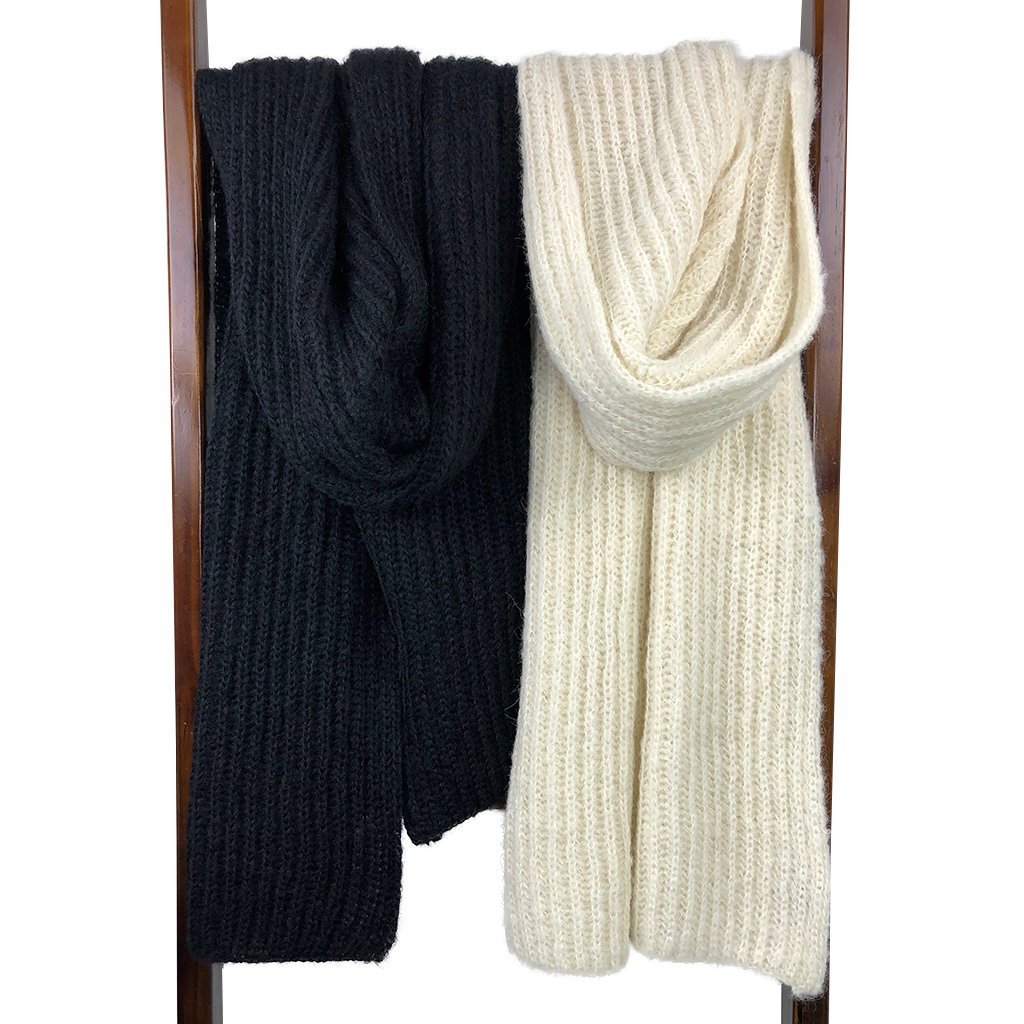 Chunky black knit alpaca scarf, oversized and unisex, showcasing its luxurious texture and unique handmade quality.