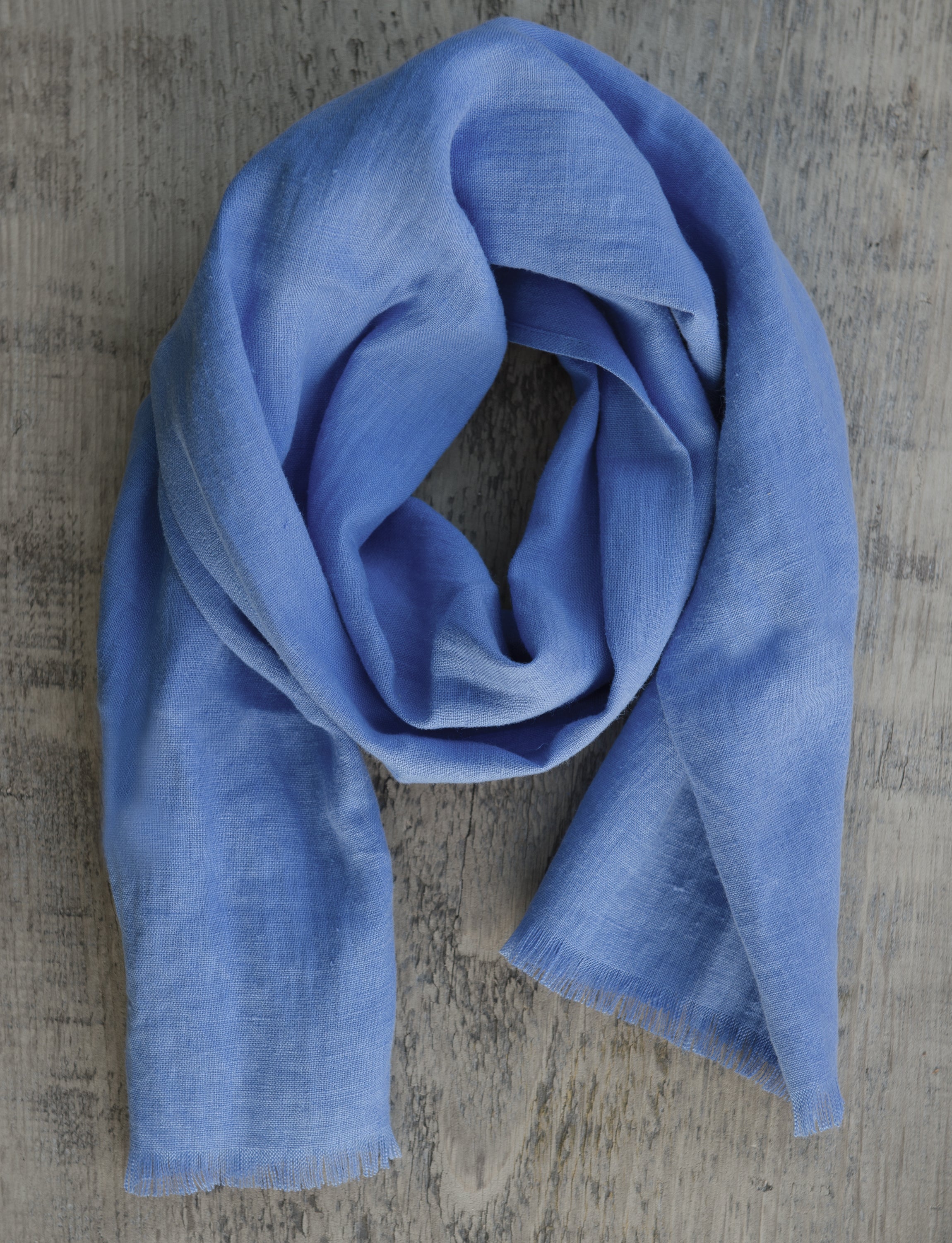 Cornflower Blue linen scarf made from 100% stonewashed linen, showcasing its elegant design and soft texture.