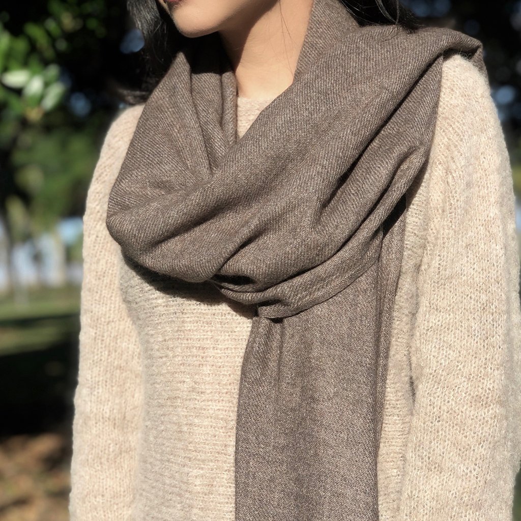 Espresso Handloom Cashmere Scarf draped elegantly, showcasing its soft texture and unique patterns, handmade by artisans in Nepal.