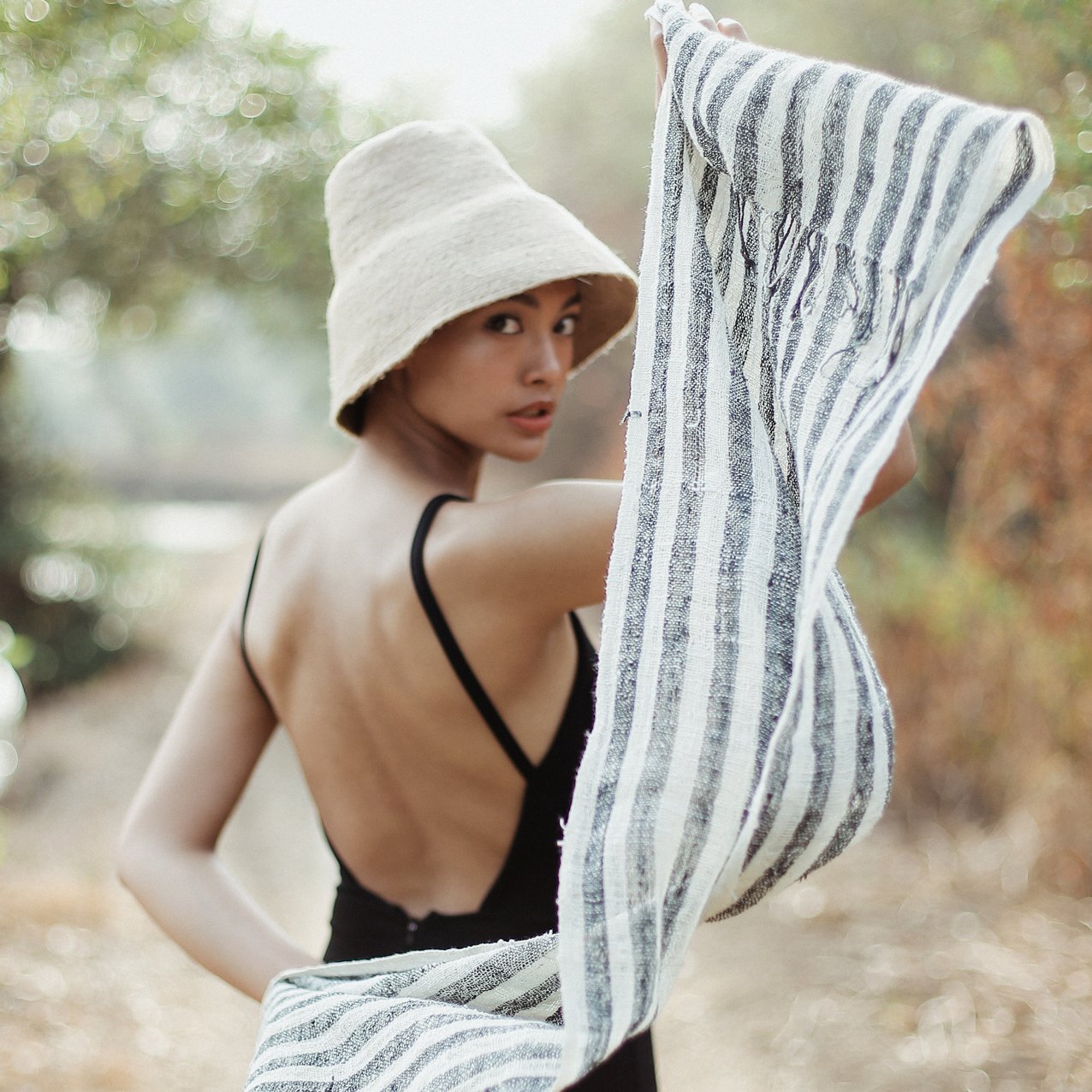 Fatima Hand-loomed Raw Cotton Scarf in Black with striped texture and fringe knots, showcasing artisanal craftsmanship.