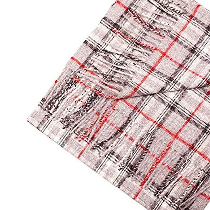 A luxurious grey scarf made from 100% baby alpaca wool, showcasing its soft texture and elegant design, perfect for winter wear.