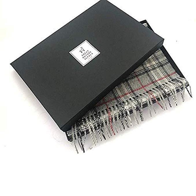 A luxurious grey scarf made from 100% baby alpaca wool, showcasing its soft texture and elegant design, perfect for winter wear.