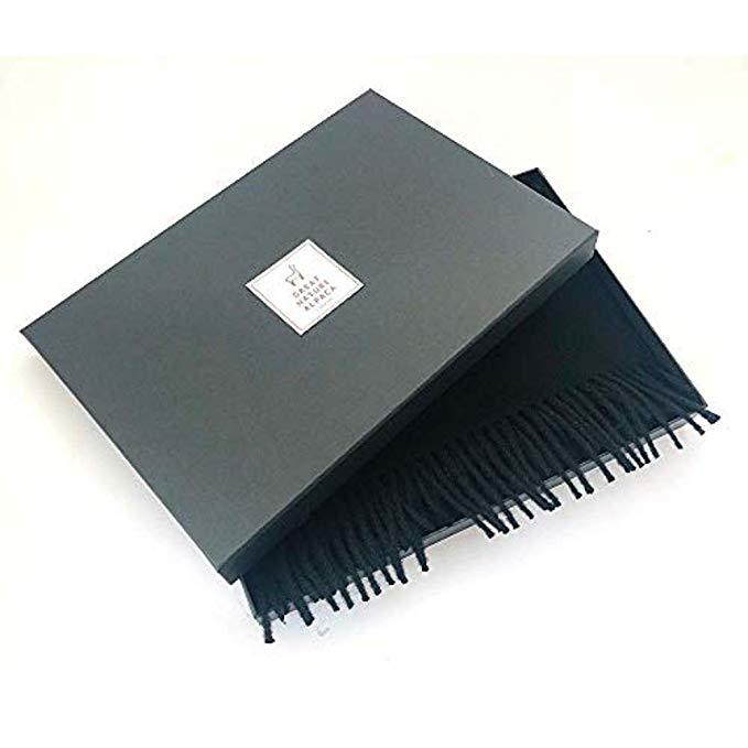 Luxurious black scarf made from 100% super baby alpaca wool, showcasing its soft texture and elegant design.