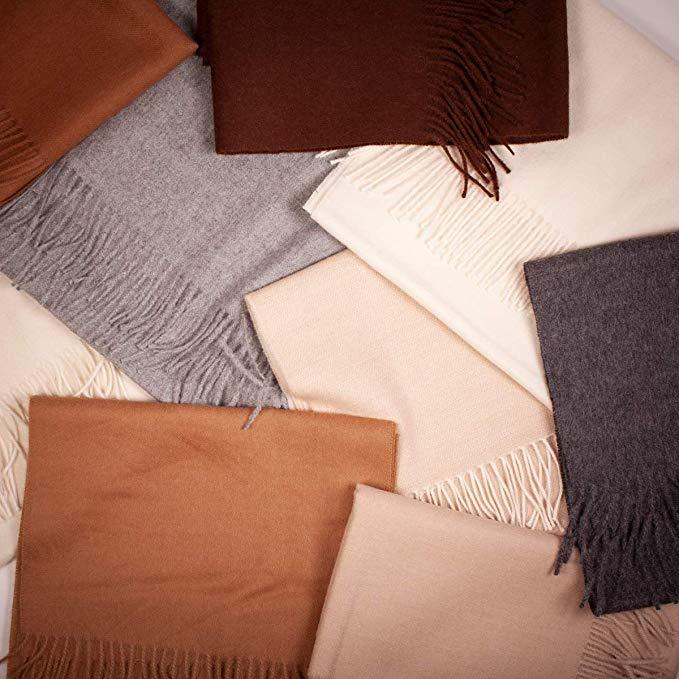 Luxurious camel-colored shawl made from 70% baby alpaca and 30% silk, showcasing its soft texture and elegant design.