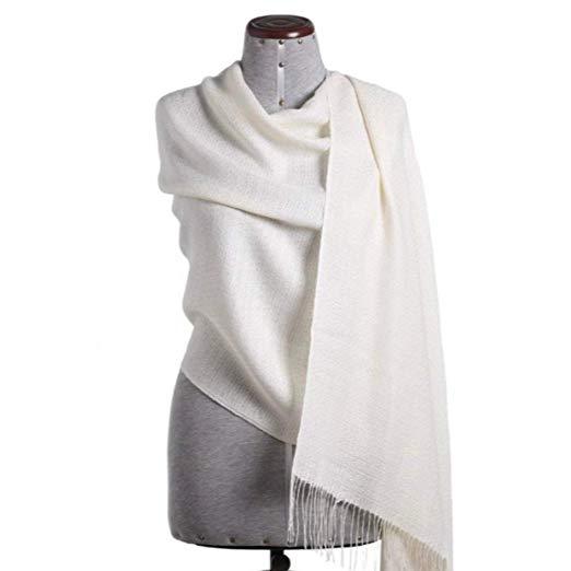 Luxurious white shawl made from 70% baby alpaca and 30% silk, showcasing its soft texture and elegant design.