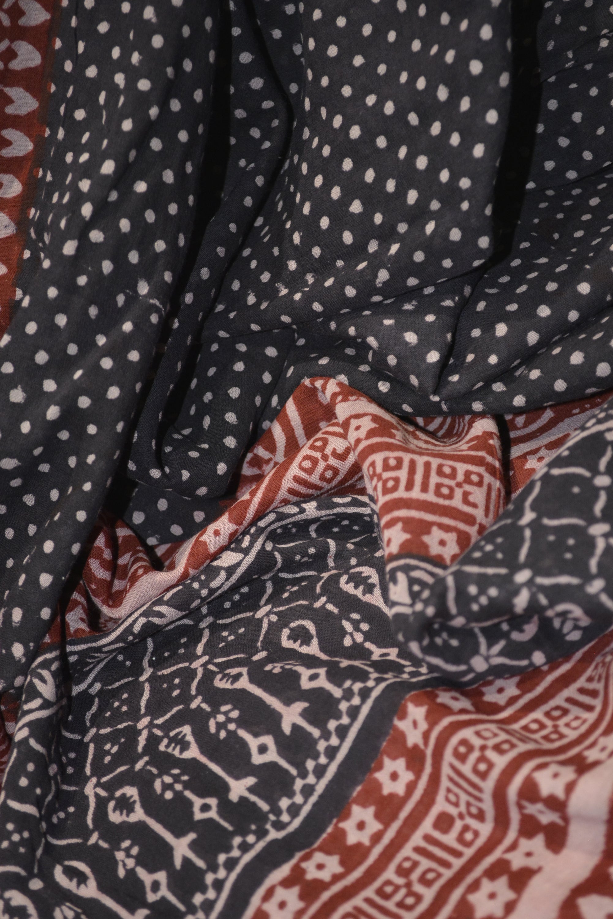 Red and black paisley design hand block printed cotton fabric showcasing intricate floral patterns and vintage motifs.