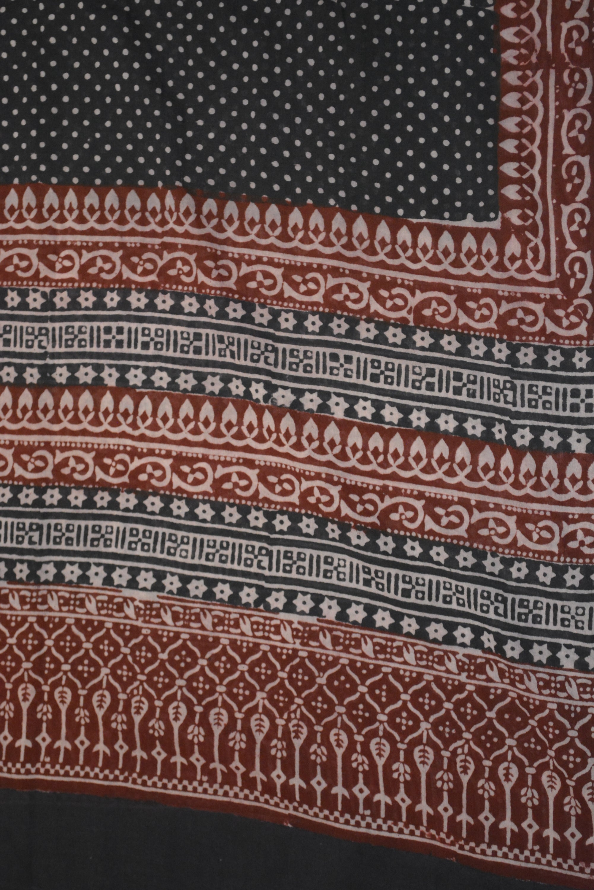 Red and black paisley design hand block printed cotton fabric showcasing intricate floral patterns and vintage motifs.