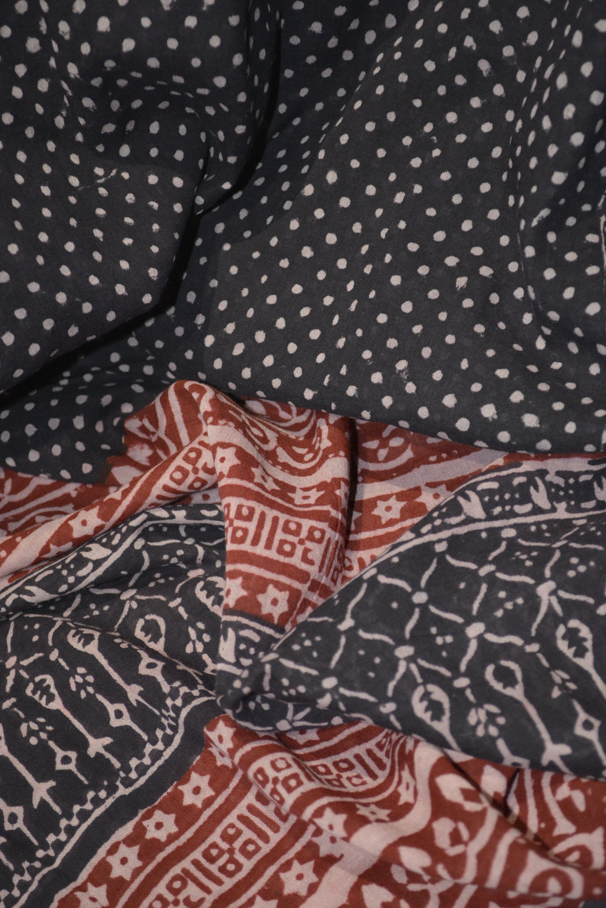 Red and black paisley design hand block printed cotton fabric showcasing intricate floral patterns and vintage motifs.