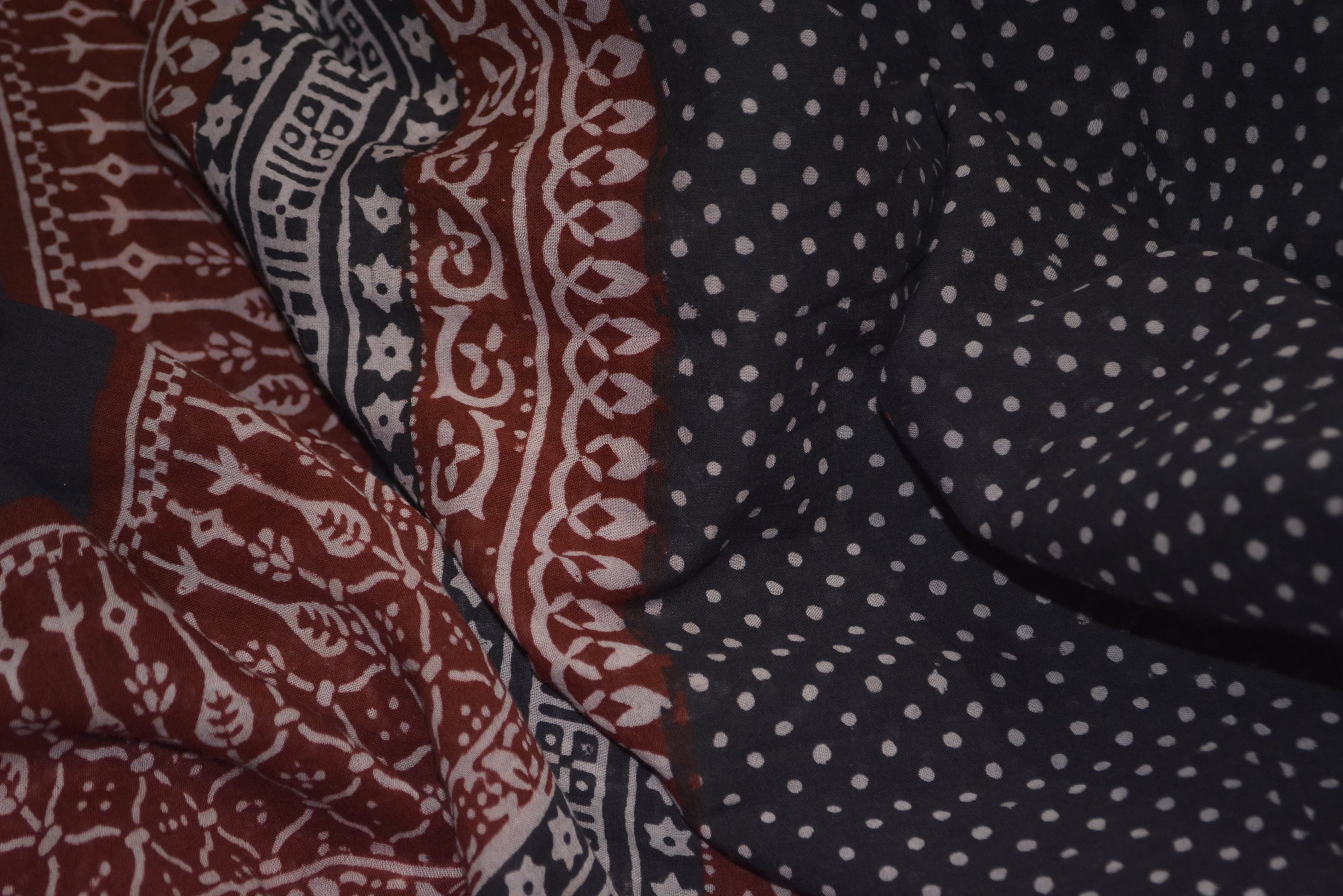 Red and black paisley design hand block printed cotton fabric showcasing intricate floral patterns and vintage motifs.