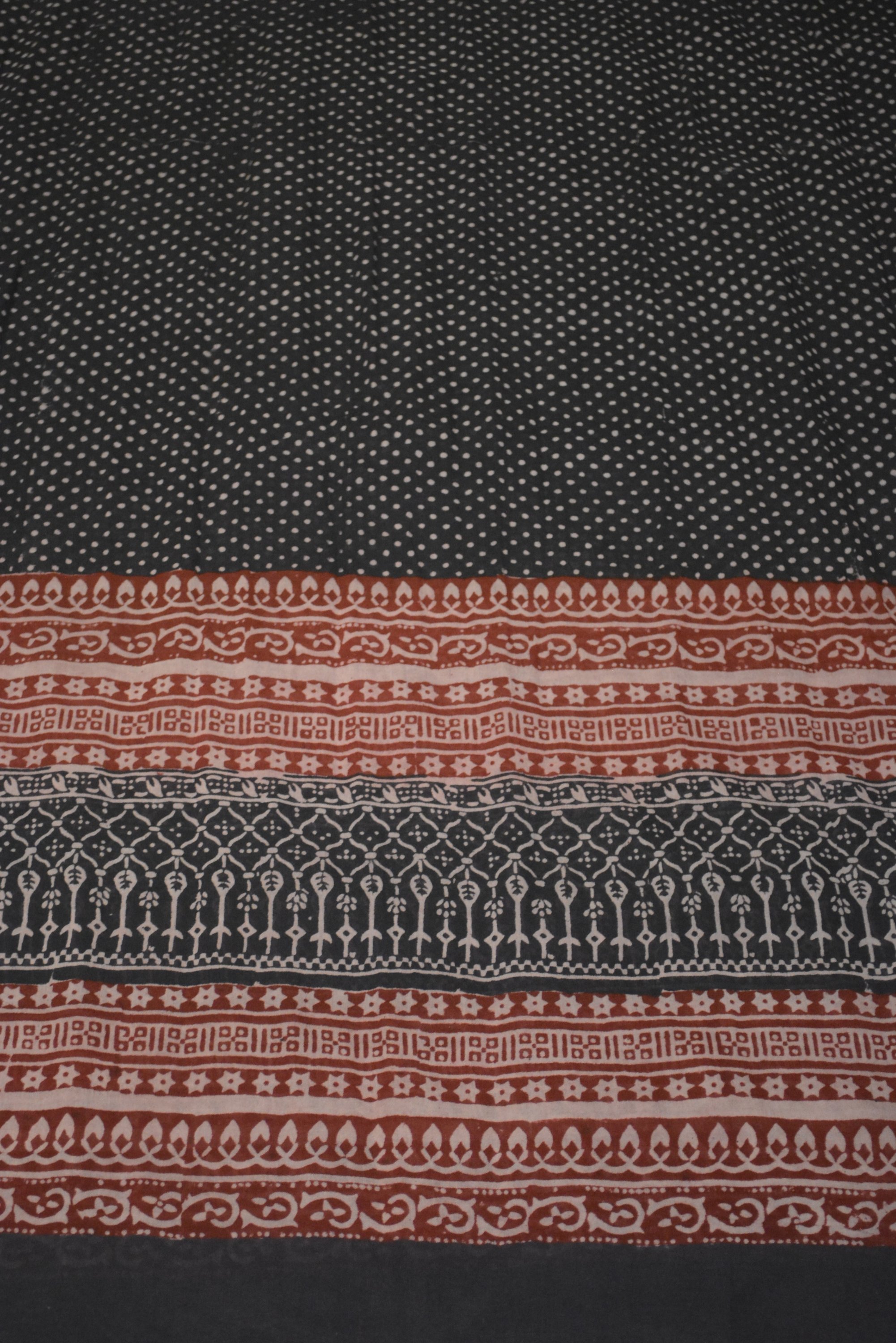 Red and black paisley design hand block printed cotton fabric showcasing intricate floral patterns and vintage motifs.