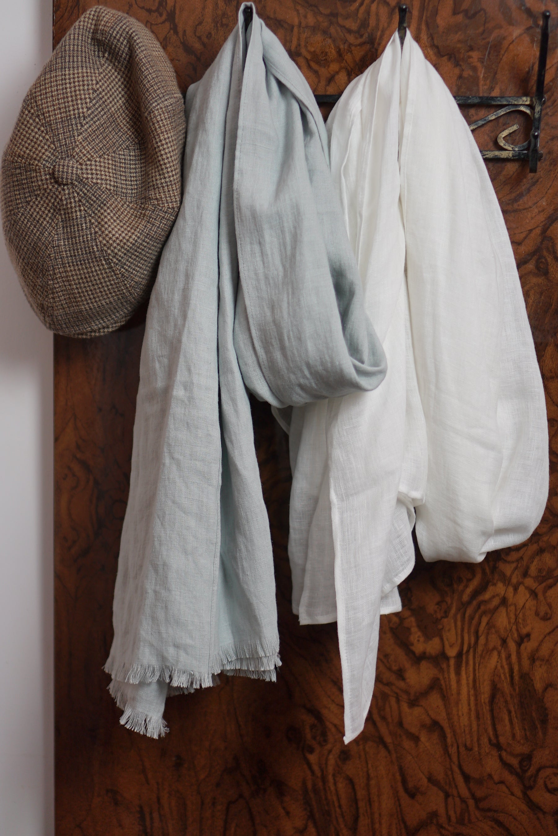A stylish white linen scarf made from 100% stonewashed linen, showcasing its soft texture and elegant design.